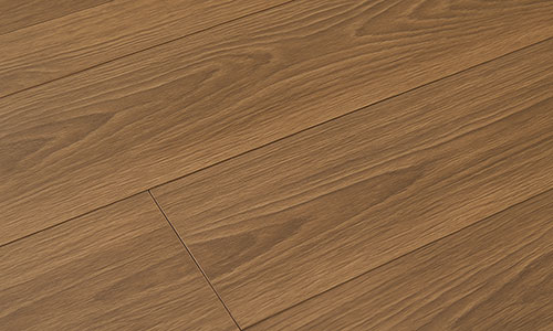 Close-up view of wooden floorboards with a natural brown finish, showing wood grain patterns and seams between the planks.