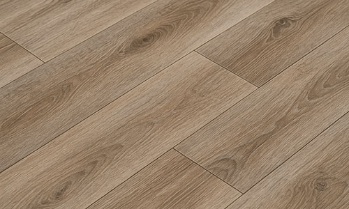 Close-up view of light brown wooden laminate flooring with a natural grain pattern and visible plank seams, arranged in a staggered pattern.